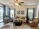 Bright living room featuring a comfortable sofa, armchairs, and a coffee table at 11249 Mc Dermott Ct, Englewood, FL 34223