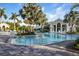 Resort-style pool with lounge chairs and a palm-tree lined deck at 11249 Mc Dermott Ct, Englewood, FL 34223