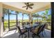Relaxing screened porch with outdoor dining furniture and backyard views at 11249 Mc Dermott Ct, Englewood, FL 34223
