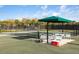 Relax under the covered seating area of this tennis court at 11249 Mc Dermott Ct, Englewood, FL 34223
