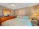 Main bedroom with wooden dresser and light teal bedding at 150 Duxbury Ave, Port Charlotte, FL 33952