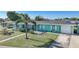 Charming light teal home with a white picket fence and spacious yard at 150 Duxbury Ave, Port Charlotte, FL 33952