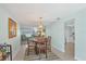 Bright dining room features a round wooden table with chairs, and view to living room at 16 Golfview Ct, Rotonda West, FL 33947