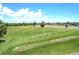 Aerial view of a lush green driving range with practice stations at 16 Golfview Ct, Rotonda West, FL 33947