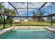 Inviting screened pool with a view of the backyard at 19 Long Meadow Ln, Rotonda West, FL 33947