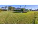 Spacious backyard with lush lawn and mature landscaping at 2 Broadmoor Rd, Rotonda West, FL 33947