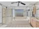 Bathroom with shower/tub combo, vanity, and built-in shelving at 2 Broadmoor Rd, Rotonda West, FL 33947
