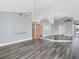Bright dining room with gray walls, wood-look floors, and a modern chandelier at 2 Broadmoor Rd, Rotonda West, FL 33947