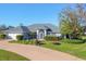 Single-story home with a two-car garage and beautifully landscaped front yard at 2 Broadmoor Rd, Rotonda West, FL 33947