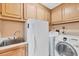 Laundry room with washer, dryer, and extra storage at 2 Broadmoor Rd, Rotonda West, FL 33947