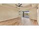Spacious living room featuring wood-look floors and access to a scenic backyard at 2 Broadmoor Rd, Rotonda West, FL 33947