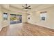 Bright living room with wood-look floors and sliding glass doors leading to a patio at 2 Broadmoor Rd, Rotonda West, FL 33947