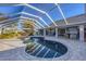 Inviting pool area with screened enclosure, spa, and ample patio space at 2 Broadmoor Rd, Rotonda West, FL 33947