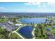 Aerial view of community with lake and clubhouse at 2 Marker Rd, Rotonda West, FL 33947