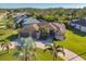 Beautiful home featuring mature landscaping, circular driveway, and a three-car garage at 2 Marker Rd, Rotonda West, FL 33947