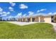 Community clubhouse with outdoor seating area and grassy lawn at 2 Marker Rd, Rotonda West, FL 33947