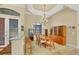 Bright dining room with a wooden table, chandelier, and built-in hutch at 2 Marker Rd, Rotonda West, FL 33947