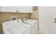 Laundry room with washer and dryer, cabinets and door at 2 Marker Rd, Rotonda West, FL 33947