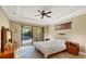 Spacious main bedroom with pool access and ceiling fan at 2 Marker Rd, Rotonda West, FL 33947