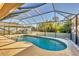 Kidney shaped screened pool with patio area at 2 Marker Rd, Rotonda West, FL 33947