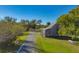 Nature trail with mature trees and a rustic building at 2 Marker Rd, Rotonda West, FL 33947