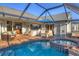 Enclosed pool and spa with patio furniture at 213 White Marsh Ln, Rotonda West, FL 33947