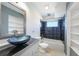 Clean bathroom with updated bathtub and shelving at 2210 Hayworth Rd, Port Charlotte, FL 33952