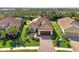 Aerial view of a single-Gathering home with a tile roof and a paved driveway at 26790 Weiskopf Dr, Englewood, FL 34223