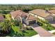 Aerial view of single Gathering house with tile roof and paved driveway at 26790 Weiskopf Dr, Englewood, FL 34223
