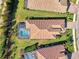 Aerial view of a home with a pool and patio, nestled in a neighborhood at 26790 Weiskopf Dr, Englewood, FL 34223