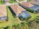 Aerial view of house and pool with screened enclosure in a community setting at 26790 Weiskopf Dr, Englewood, FL 34223