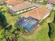 An aerial view of a house with a screened-in pool and lush landscaping at 26790 Weiskopf Dr, Englewood, FL 34223