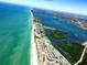 Aerial view of coastal property showing beach, ocean, and residential area at 26790 Weiskopf Dr, Englewood, FL 34223