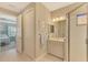 Well-appointed bathroom with single vanity, shower, and updated fixtures at 26790 Weiskopf Dr, Englewood, FL 34223