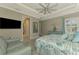 Serene bedroom with a king bed, sitting area, and views into bathroom at 26790 Weiskopf Dr, Englewood, FL 34223