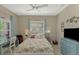 Guest bedroom with queen bed, window, and light decor at 26790 Weiskopf Dr, Englewood, FL 34223