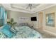 Spacious bedroom with coastal decor, featuring a king-size bed and sitting area at 26790 Weiskopf Dr, Englewood, FL 34223