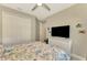 Bright bedroom with a large closet and TV at 26790 Weiskopf Dr, Englewood, FL 34223