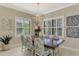 Bright dining room with a wood table and seating for six at 26790 Weiskopf Dr, Englewood, FL 34223