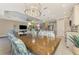 Open dining room with dark wood table and kitchen views at 26790 Weiskopf Dr, Englewood, FL 34223