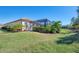 Single-story house with a tile roof, and well maintained lawn at 26790 Weiskopf Dr, Englewood, FL 34223