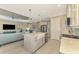Open kitchen with island, stainless steel appliances, and view into living room at 26790 Weiskopf Dr, Englewood, FL 34223