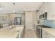 Kitchen features a farmhouse sink, stainless steel appliances, and light wood flooring at 26790 Weiskopf Dr, Englewood, FL 34223