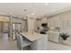 Modern kitchen with white cabinets, stainless steel appliances, and large island at 26790 Weiskopf Dr, Englewood, FL 34223