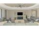 Living room features gray sofas, a large TV, and a coffee table at 26790 Weiskopf Dr, Englewood, FL 34223