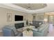 Relaxing living room with plush seating and large TV at 26790 Weiskopf Dr, Englewood, FL 34223