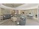 Open living and kitchen area with gray sofas and an island at 26790 Weiskopf Dr, Englewood, FL 34223