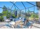 Relaxing screened patio with lounge furniture at 26790 Weiskopf Dr, Englewood, FL 34223