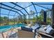 Screened pool and patio with comfortable seating at 26790 Weiskopf Dr, Englewood, FL 34223
