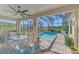 Relaxing screened pool area with outdoor dining at 26790 Weiskopf Dr, Englewood, FL 34223